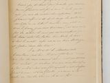 an open book with a handwritten letter on it sitting on top of a table