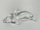 clear glass figurine of a cat with a bow on its tail