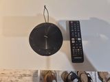 a remote control and a clock on the wall