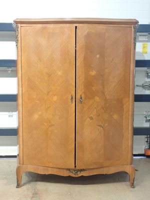a wooden cabinet with two doors in a room