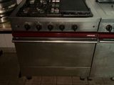 a kitchen with a stove, oven, and a pot on the counter
