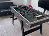 a foosball table in the corner of a living room