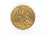 a gold coin with a bird on it on a white surface