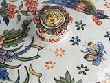 a close up of a decorative vase with flowers on it