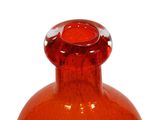 an orange glass vase with a red top on a white background
