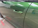 a close up of a car door handle on the side of the road