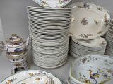 many plates and bowls that are sitting on a table