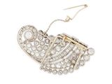 a gold and diamond broochle with a chain