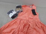 peach colored dress with tags on it sitting on a couch