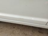 a picture of a white car parked in a parking lot