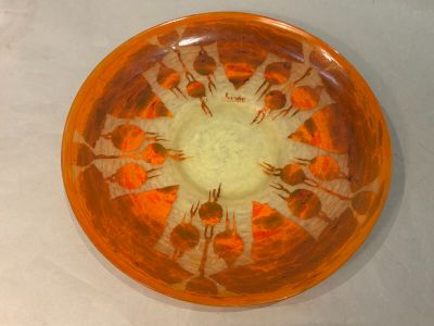 an orange bowl with orange flowers on it
