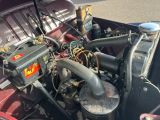 a close up of a car ' s engine with the hood open