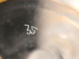 a close up of a glass of water with a number 55 on it