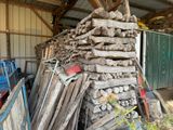 a pile of wood stacked on top of each other in a shed