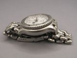 a silver watch with a chain attached to it