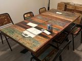 a wooden table and chairs in a room with a window