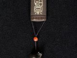 a close up of a book with a bell hanging from it ' s neck
