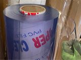 a roll of clear plastic sitting on top of a pile of boxes