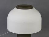 a close up of a lamp on a table with a gray background