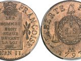 a close up of a coin on a white surface