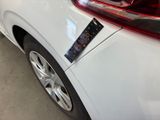 a sticker on the back of a white car that has a sticker on it