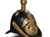 un vieux casque orné d'un dragon sur le dessus et d'un autre sur le côté