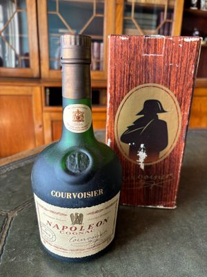 a bottle of liquor sitting on a table next to a box