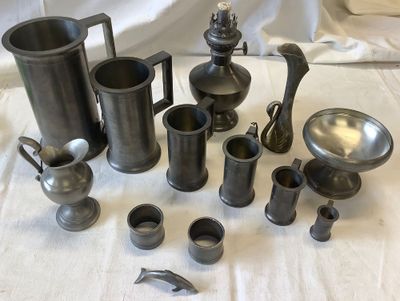 many different types of pewware sitting on a table