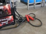a car charger sitting on the ground next to a car battery