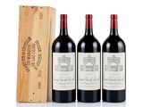 three bottles of red wine and a wooden box on a white surface
