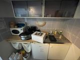 a small kitchen with a microwave, a sink, and a microwave oven
