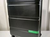 a black suitcase with a green handle sitting on a table