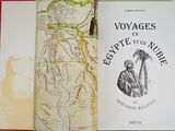 a book that is open on a table with a map in the background