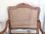 a wooden chair with a wicker back and a wooden seat