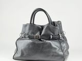 an image of a black leather handbag sitting on top of a white surface