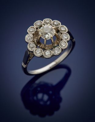 an old cut diamond ring with a center stone surrounded by small round diamonds