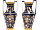 pair of blue and gold vases sitting on a white surface