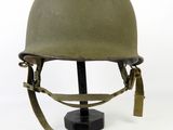 an old military helmet with a metal stand on a white background
