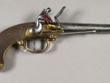 a close up of a toy gun on a white surface