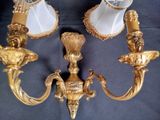 two gold candles that are sitting on a table