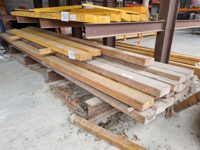 several pieces of wood are stacked on top of each other in a warehouse