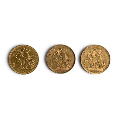 three different types of gold coins on a white surface