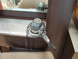 a sink with a faucet and a mirror in the background