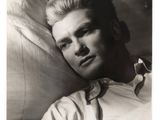 black and white photograph of a man laying on a pillow