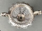 a silver plate with a turtle on it on a table
