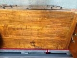 a wooden chest with a metal latch on it