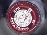 a close up view of a wine bottle with a red cap