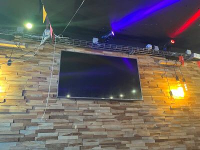 a television mounted on the wall of a restaurant