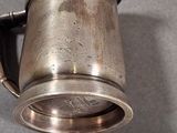 a silver cup that is sitting on a table