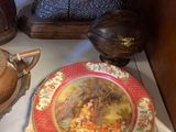 a plate with a painting on it sitting on a table